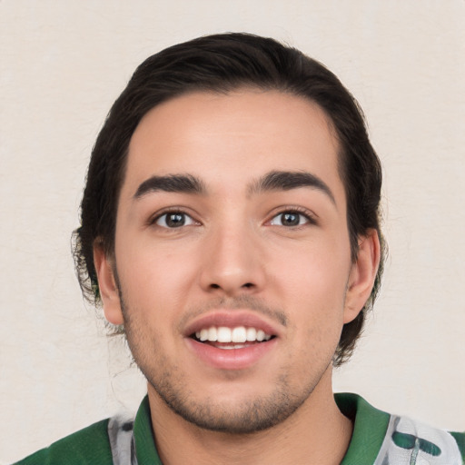 Joyful white young-adult male with short  black hair and brown eyes