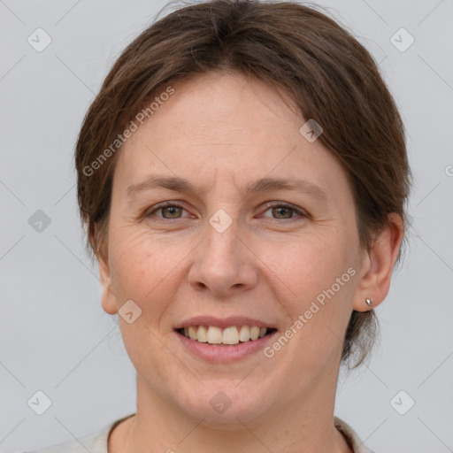 Joyful white adult female with medium  brown hair and grey eyes