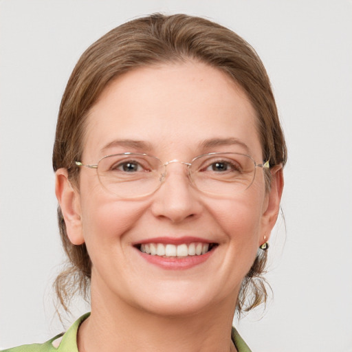 Joyful white adult female with medium  brown hair and grey eyes