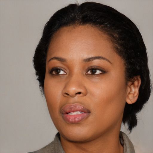 Joyful black young-adult female with medium  black hair and brown eyes