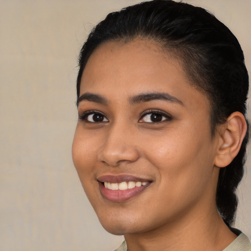 Joyful latino young-adult female with short  brown hair and brown eyes