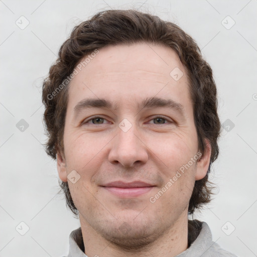 Joyful white adult male with short  brown hair and grey eyes