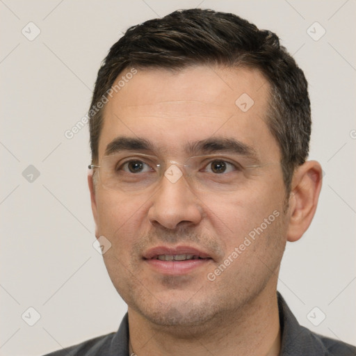 Joyful white adult male with short  black hair and brown eyes