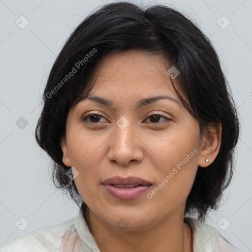 Joyful latino adult female with medium  brown hair and brown eyes