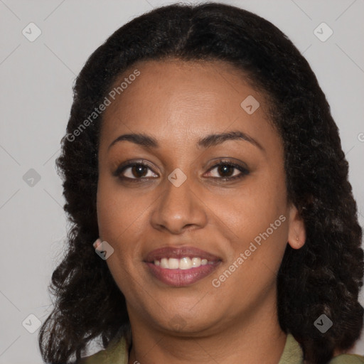 Joyful black young-adult female with long  brown hair and brown eyes