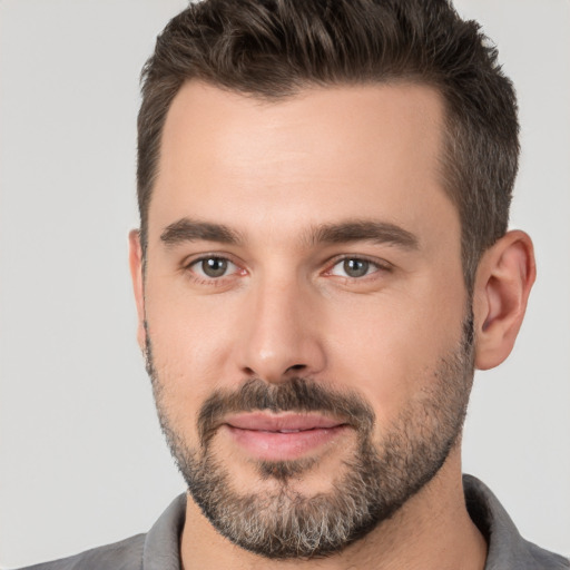 Joyful white young-adult male with short  brown hair and brown eyes