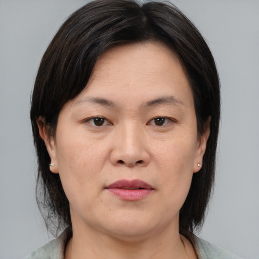 Joyful asian adult female with medium  brown hair and brown eyes