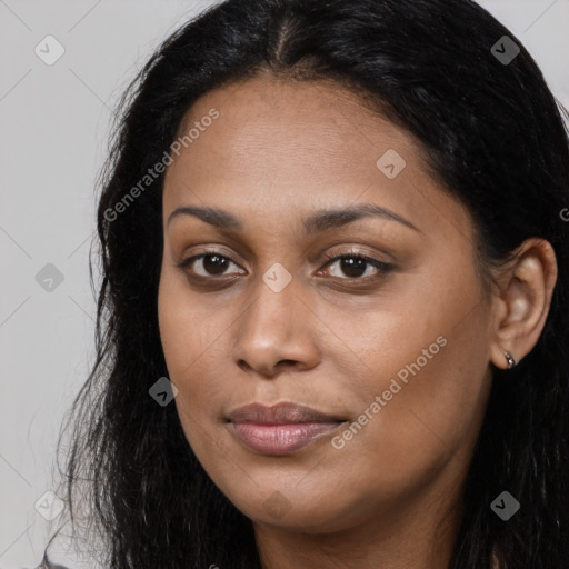 Joyful black young-adult female with long  brown hair and brown eyes