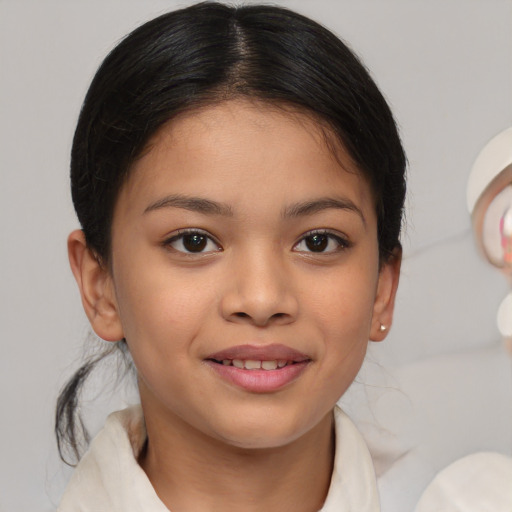 Joyful latino child female with medium  brown hair and brown eyes