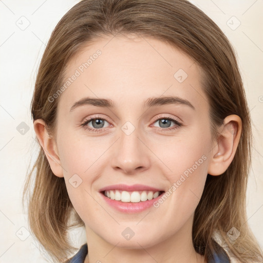 Joyful white young-adult female with long  brown hair and blue eyes