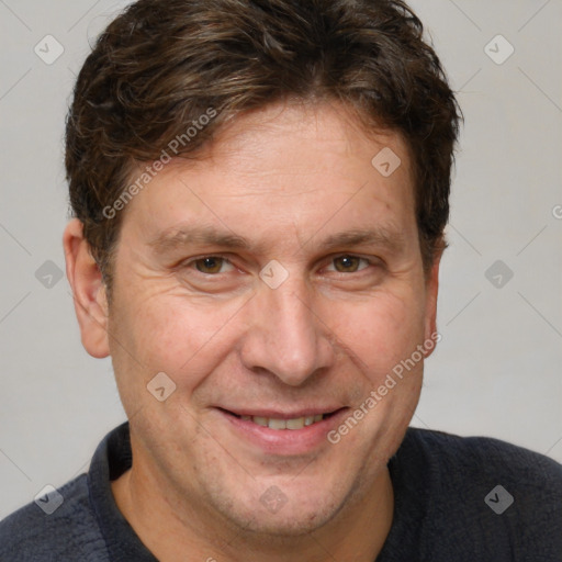 Joyful white adult male with short  brown hair and grey eyes