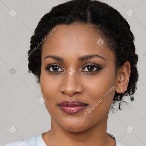 Joyful black young-adult female with long  black hair and brown eyes