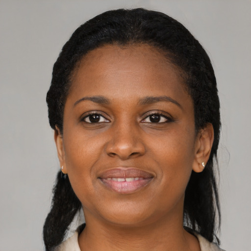 Joyful black young-adult female with medium  black hair and brown eyes