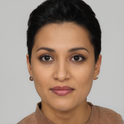 Joyful latino young-adult female with short  black hair and brown eyes