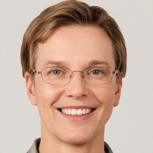 Joyful white adult male with short  brown hair and grey eyes