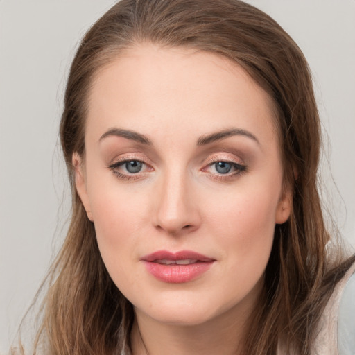 Joyful white young-adult female with long  brown hair and grey eyes