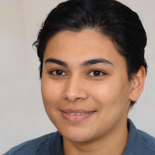 Joyful latino young-adult female with medium  brown hair and brown eyes