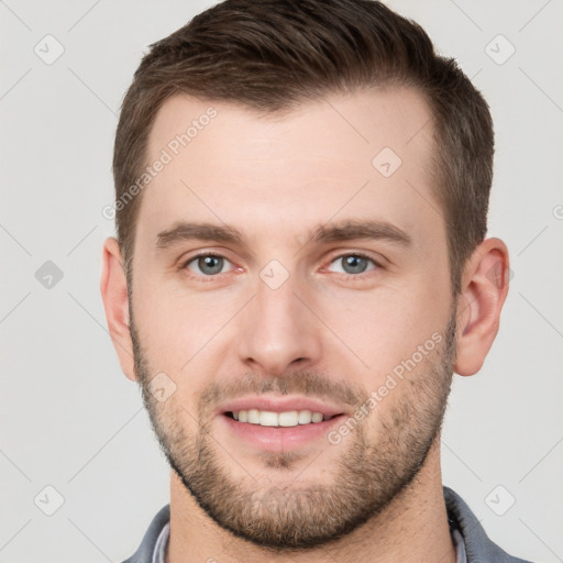 Joyful white young-adult male with short  brown hair and grey eyes