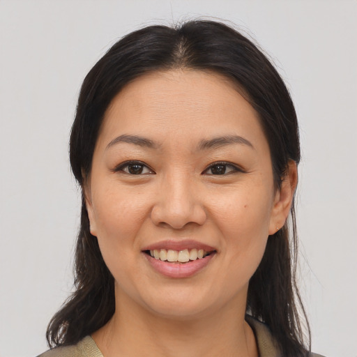 Joyful asian young-adult female with medium  brown hair and brown eyes