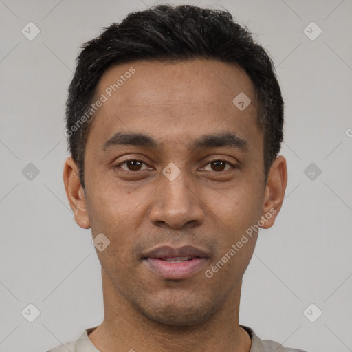 Joyful latino young-adult male with short  black hair and brown eyes