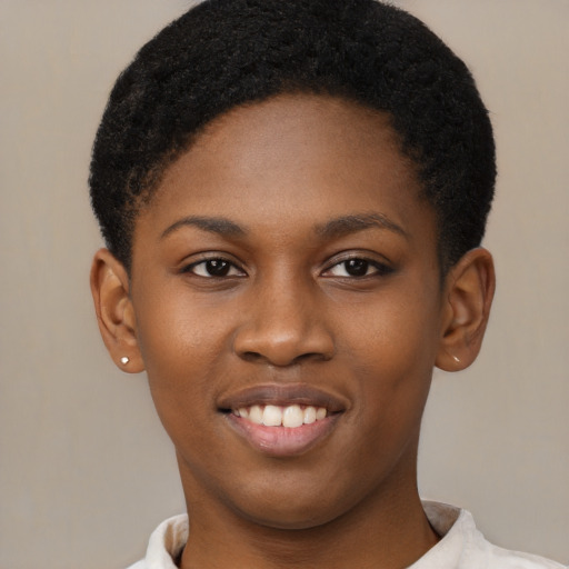 Joyful black young-adult female with short  black hair and brown eyes