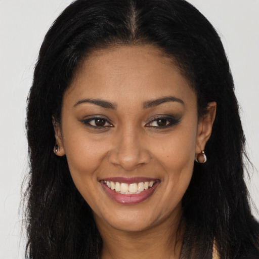 Joyful latino young-adult female with long  brown hair and brown eyes