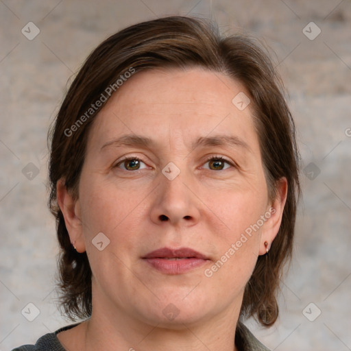 Joyful white adult female with medium  brown hair and blue eyes