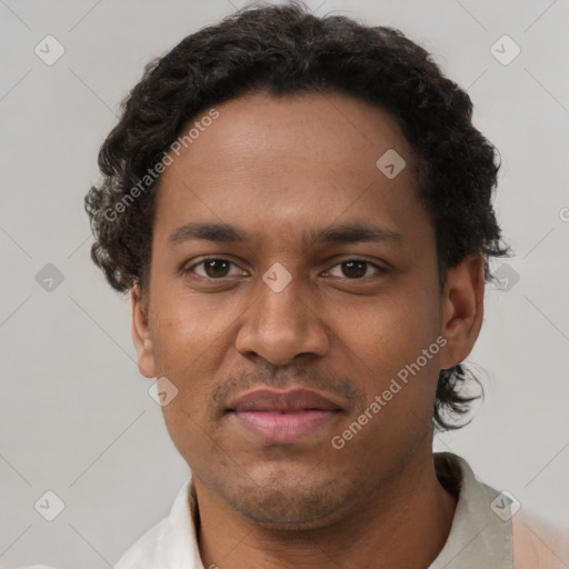 Joyful black young-adult male with short  brown hair and brown eyes