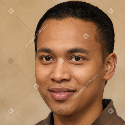 Joyful black young-adult male with short  black hair and brown eyes