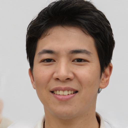 Joyful asian young-adult male with short  brown hair and brown eyes