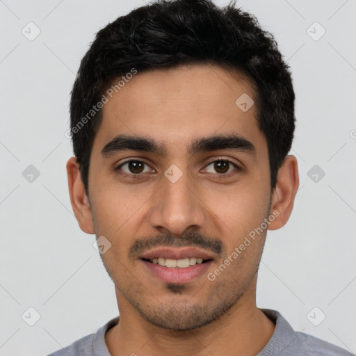 Joyful latino young-adult male with short  black hair and brown eyes