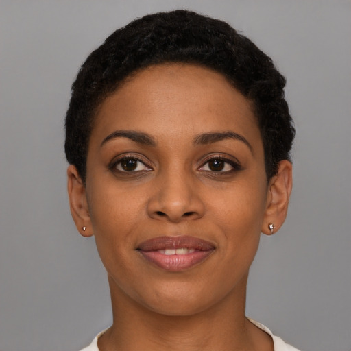 Joyful latino young-adult female with short  black hair and brown eyes