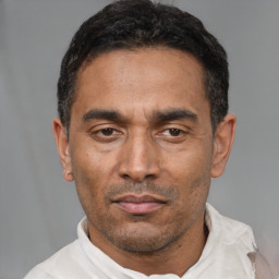 Neutral latino adult male with short  black hair and brown eyes