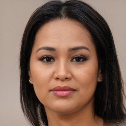 Joyful asian young-adult female with long  brown hair and brown eyes