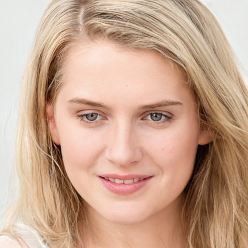 Joyful white young-adult female with long  brown hair and blue eyes