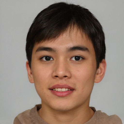 Joyful asian young-adult male with short  brown hair and brown eyes