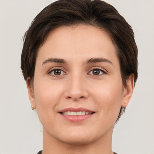 Joyful white young-adult female with short  brown hair and brown eyes