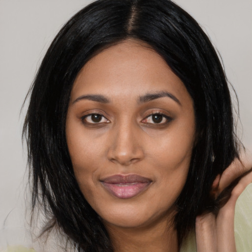Joyful asian young-adult female with long  black hair and brown eyes