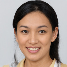 Joyful asian young-adult female with medium  brown hair and brown eyes