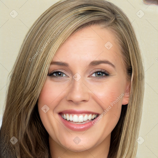 Joyful white young-adult female with long  brown hair and green eyes