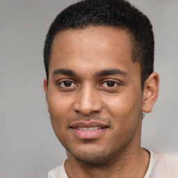 Joyful black young-adult male with short  black hair and brown eyes