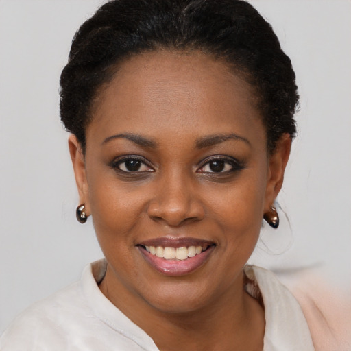 Joyful black young-adult female with short  brown hair and brown eyes