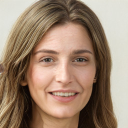 Joyful white young-adult female with long  brown hair and green eyes