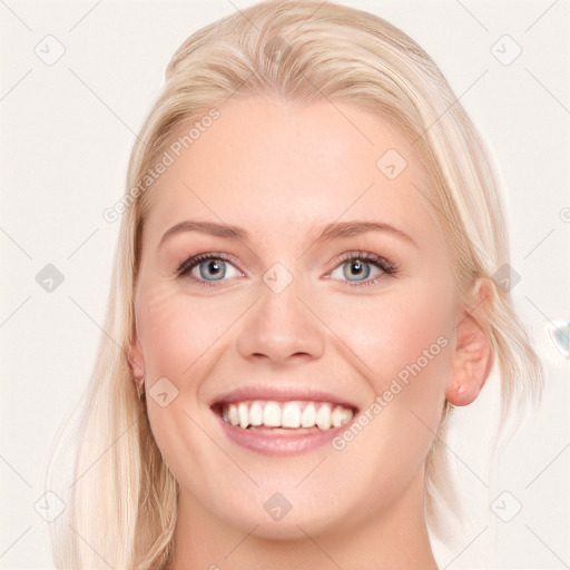 Joyful white young-adult female with long  blond hair and blue eyes