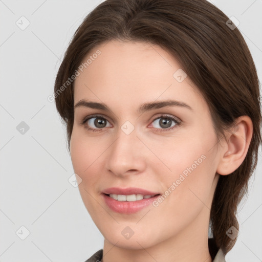 Joyful white young-adult female with medium  brown hair and grey eyes