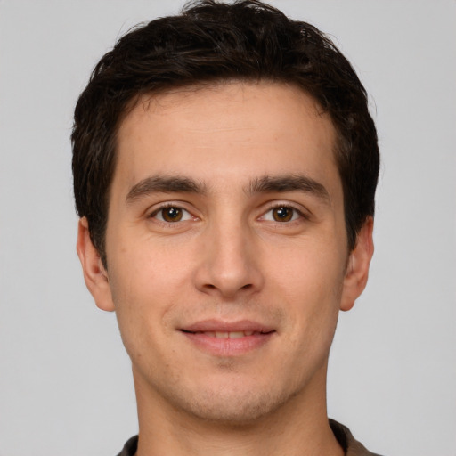 Joyful white young-adult male with short  brown hair and brown eyes