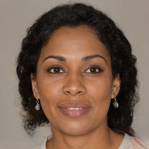 Joyful black young-adult female with medium  brown hair and brown eyes