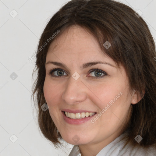 Joyful white young-adult female with medium  brown hair and green eyes