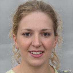 Joyful white young-adult female with medium  brown hair and grey eyes