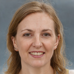 Joyful white adult female with medium  brown hair and grey eyes